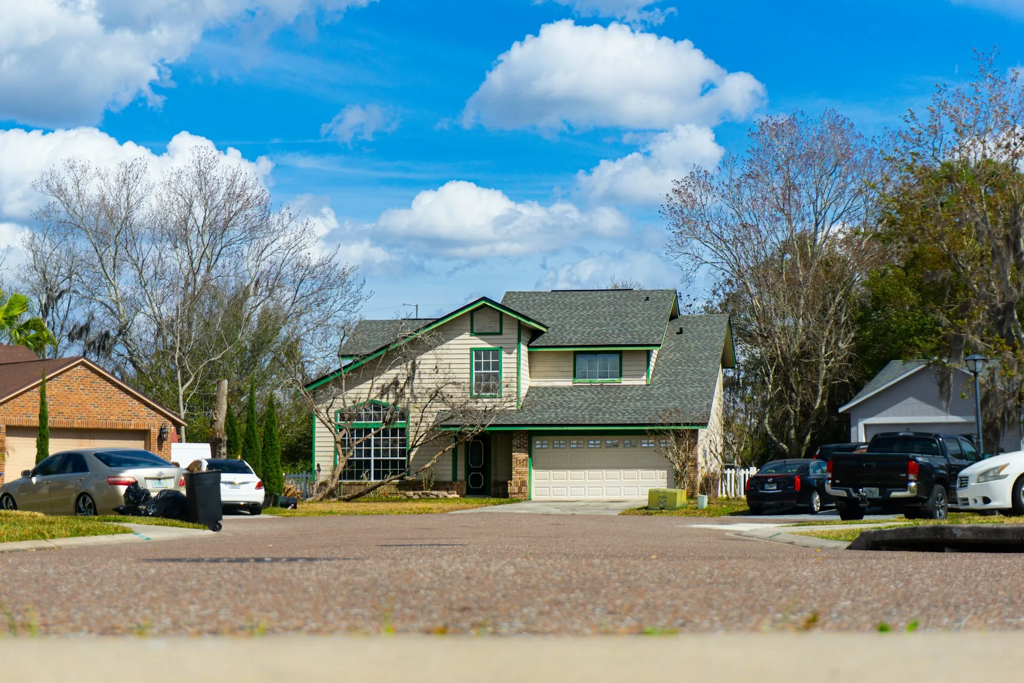 Suburban house with cars parked in the driveway
